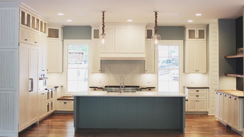 White beadboard cabinets in a modern kitchen