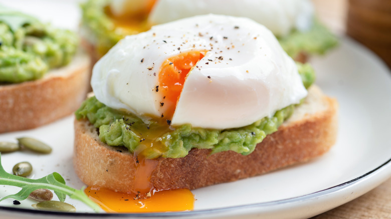 a poached egg on top of avocado toast