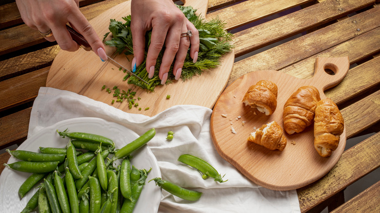person making croissants with green ingredients
