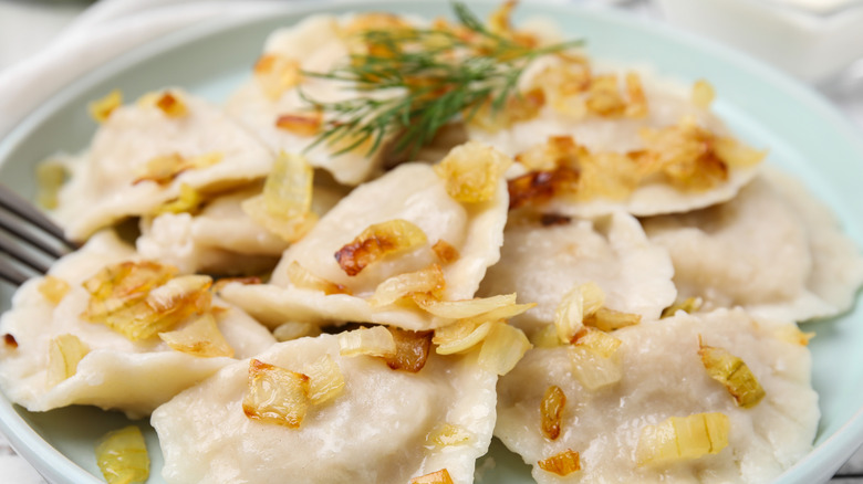 pierogi on a plate with toppings