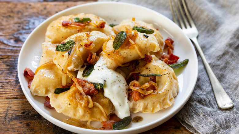 pierogi in a bowl with toppings