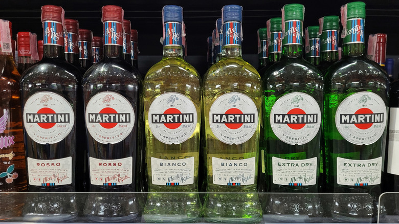bottles of red, white, and extra dry vermouth on a store shelf