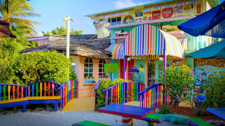 The Bubble Room's colorful exterior with benches and striped awnings