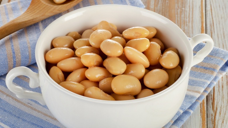 canned butter beans in a white ceramic crock