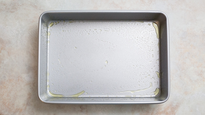 greased baking pan on table