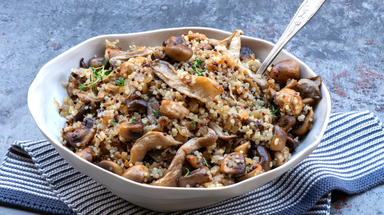 creamy quinoa and mushroom dish in white bowl