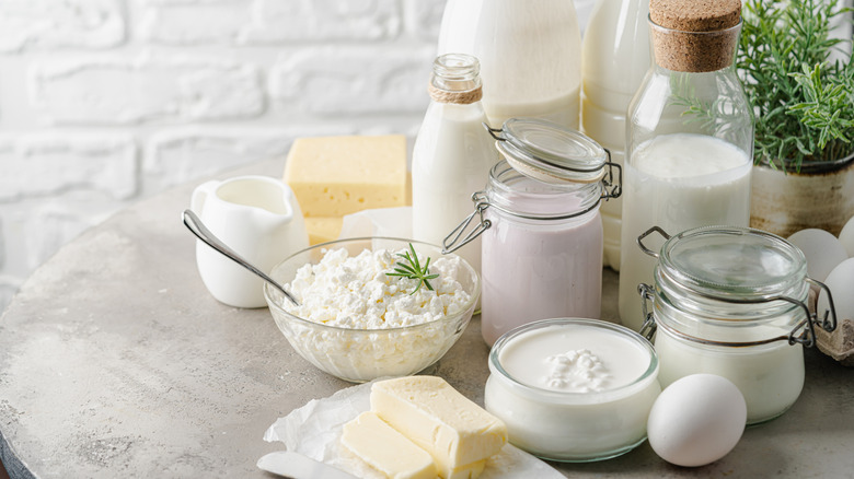 Various dairy products displayed on a round concrete table.