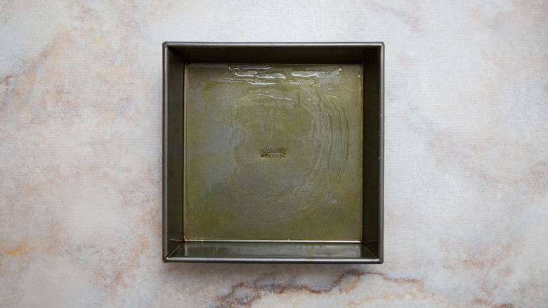 greased baking pan on table