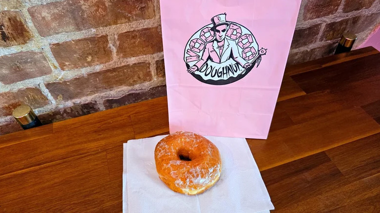 Voodoo Doughnut bag with donut on table