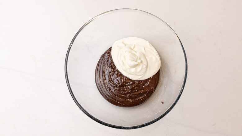 Dollops of chocolate ganache and whipped cream in bowl