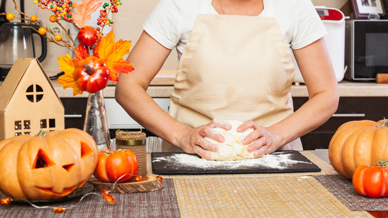 person making halloween cookies