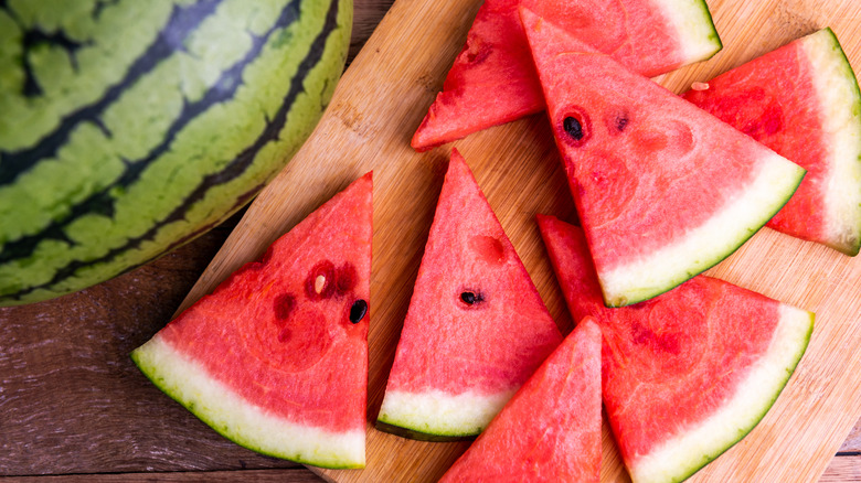 Watermelon chunks on plate in front of palm trees