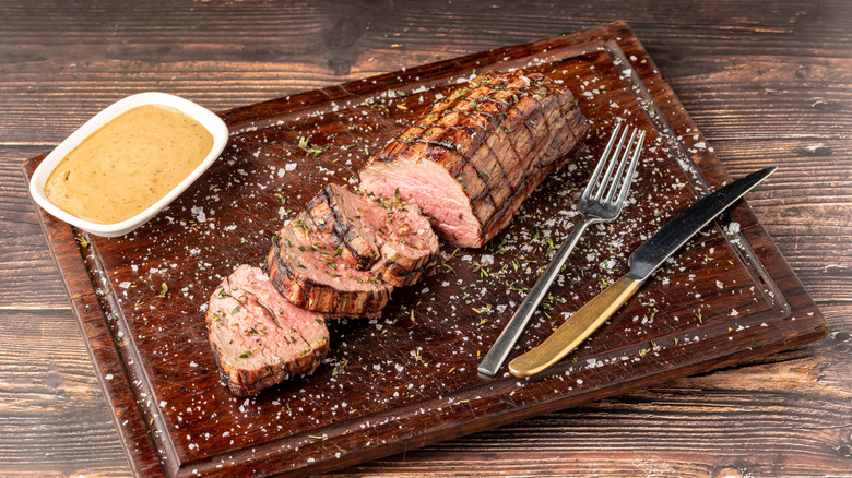 sliced and seasoned chateaubriand steak on cutting board