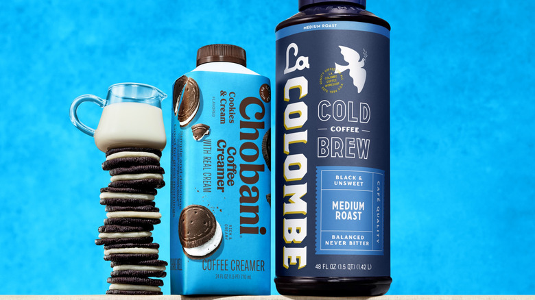 Chobani Cookies & Cream creamer beside some cookies, milk, and a cold brew