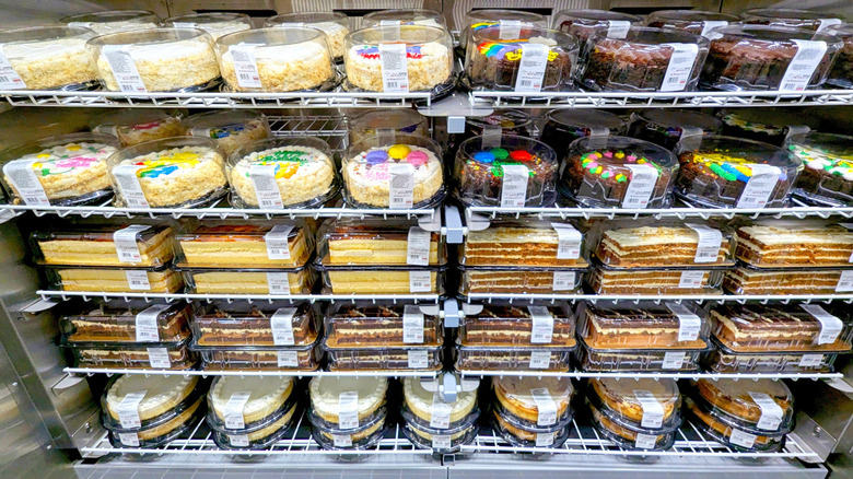 An array of Costco cakes on refrigerated shelves in the warehouse bakery