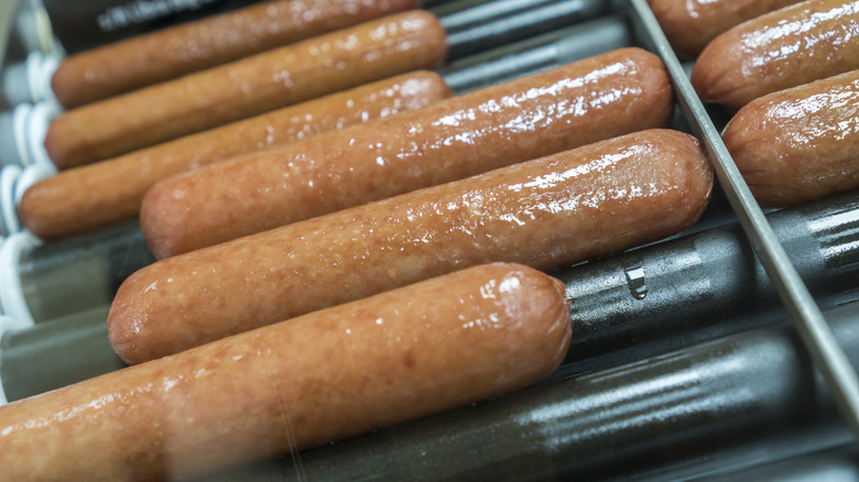 Hot dogs spinning on a griller at a 7-Eleven location