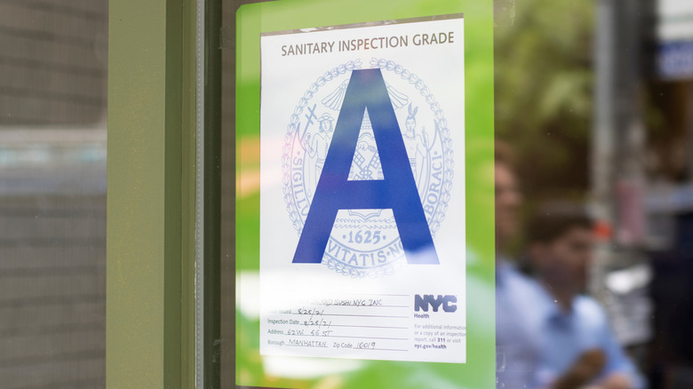 A sign showing that a restaurant scored an A sanitary inspection grade in New York City