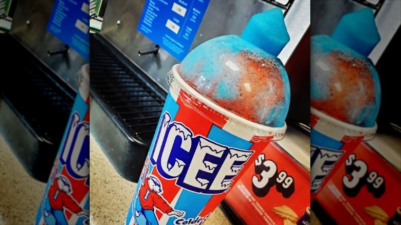 blue and red ICEE in cup with clear dome lid