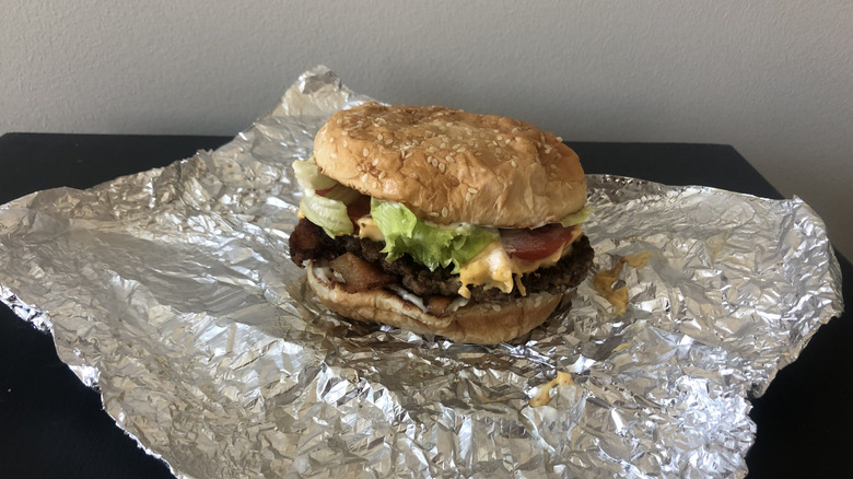 Five Guys little bacon cheeseburger over its wrapping