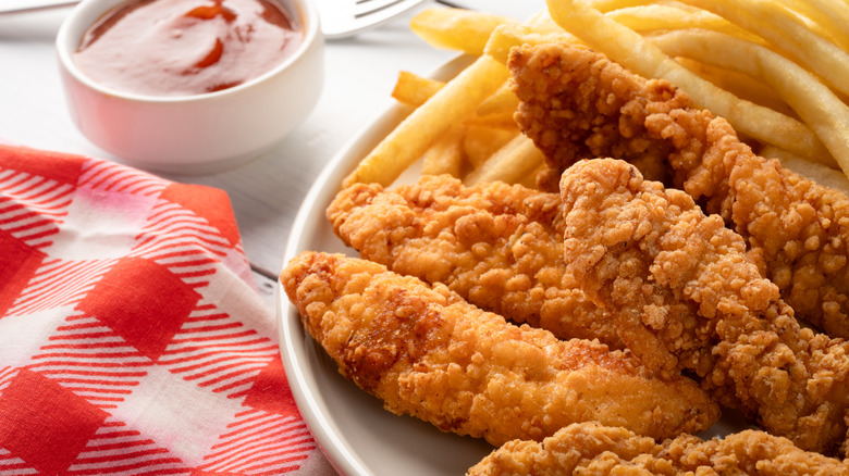 Chicken tenders and fries on plate