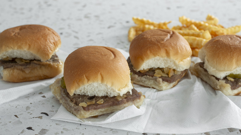 Burger sliders and fries on marble countertop