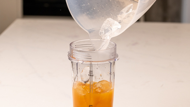 pouring ice into a blender