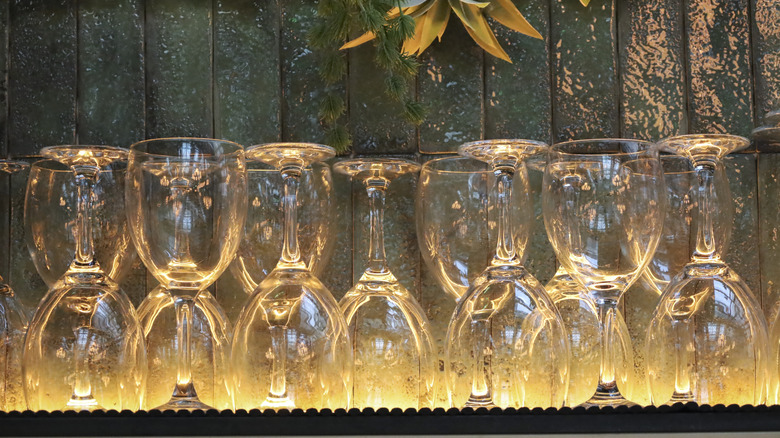 Wine glasses stacked alternately, upside down and right-side up on a shelf