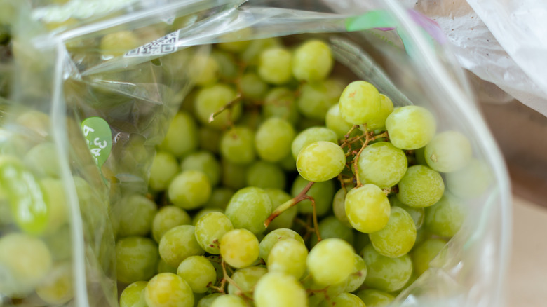 Open bag of green grapes.