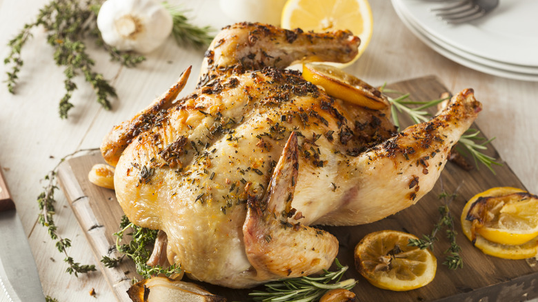 A whole roasted chicken with herbs and lemon