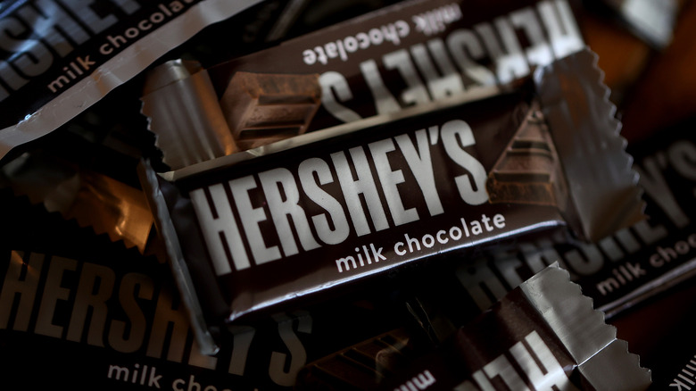Rows and rows of Hershey's milk chocolate bars in wrappers.