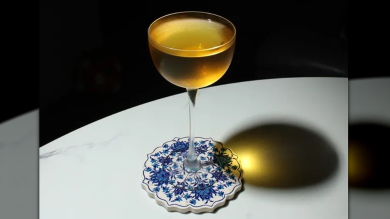 Diamondback cocktail in stemmed glass on coaster