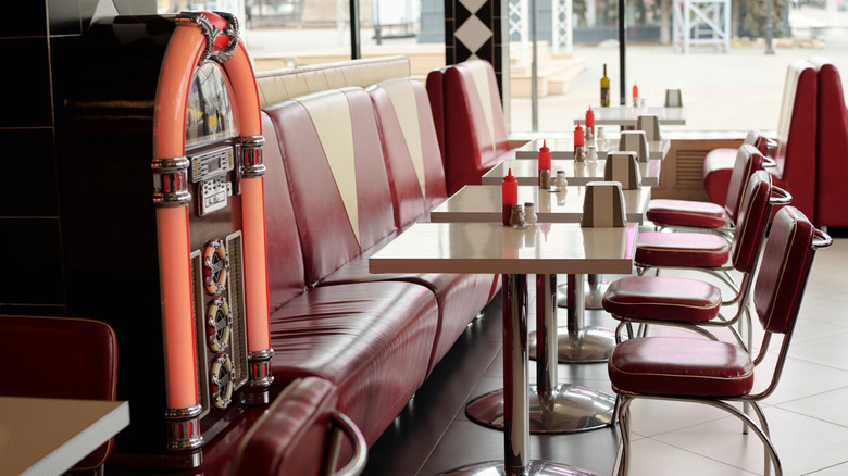 booths, tables, and a juke box at an old-school diner