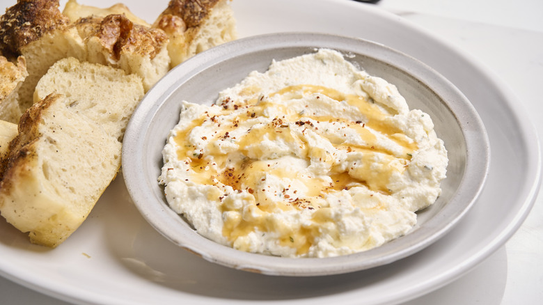 hot honey cheese dip in a bowl on a table
