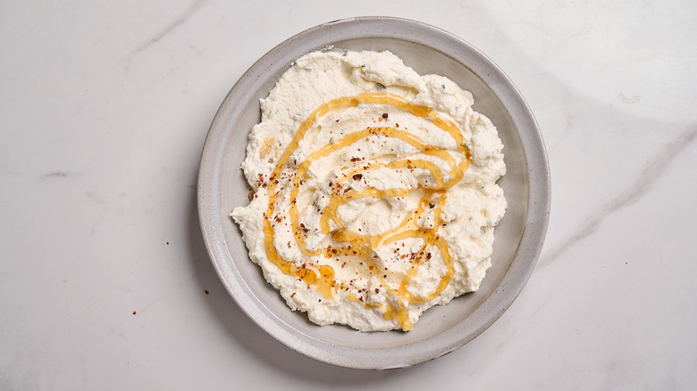 cheese dip topped with hot honey and pepper flakes