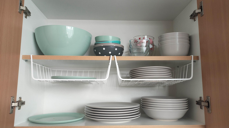 plates and bowls inside a cupboard