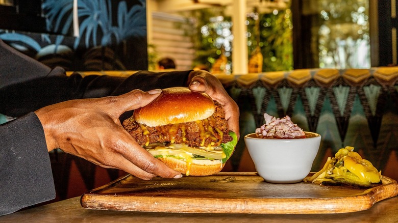 Red Rooster's friend chicken sandwich in someone's hands