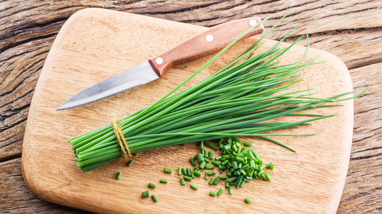 chives on cutting board with knife