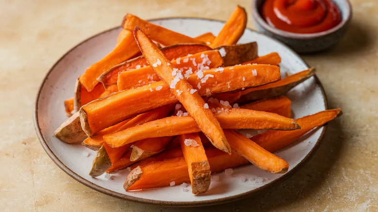 Plate of sweet potato fries topped with flaky salt