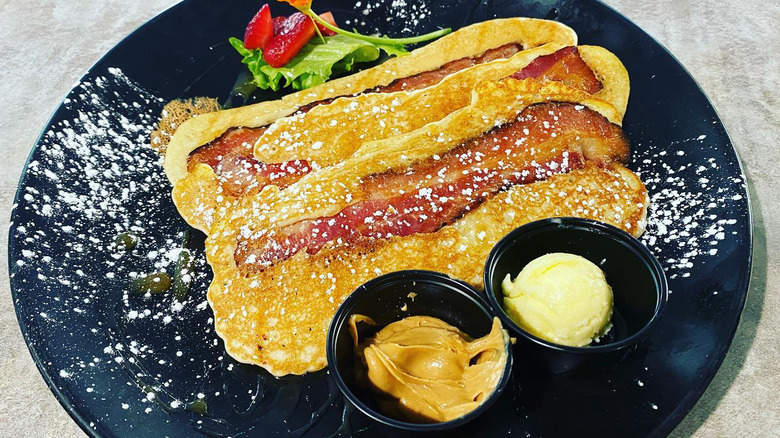 Bacon strip pancakes dusted with powdered sugar
