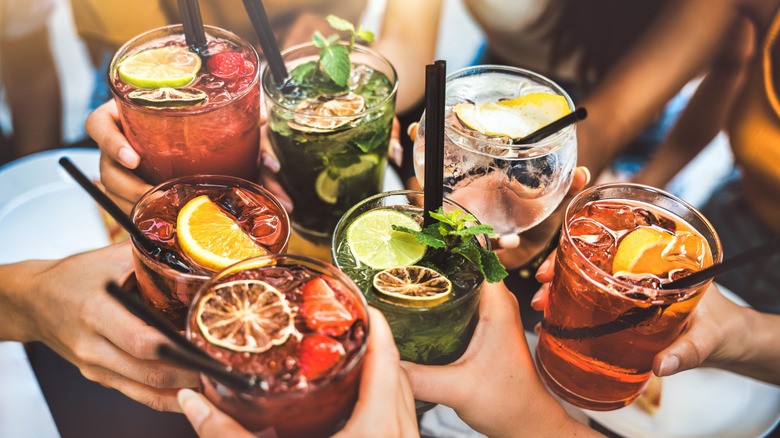 Collection of alcoholic drinks clinking together