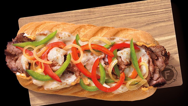 A Firehouse Subs' Smokin'  Honey Steak Melt on a wooden cutting board