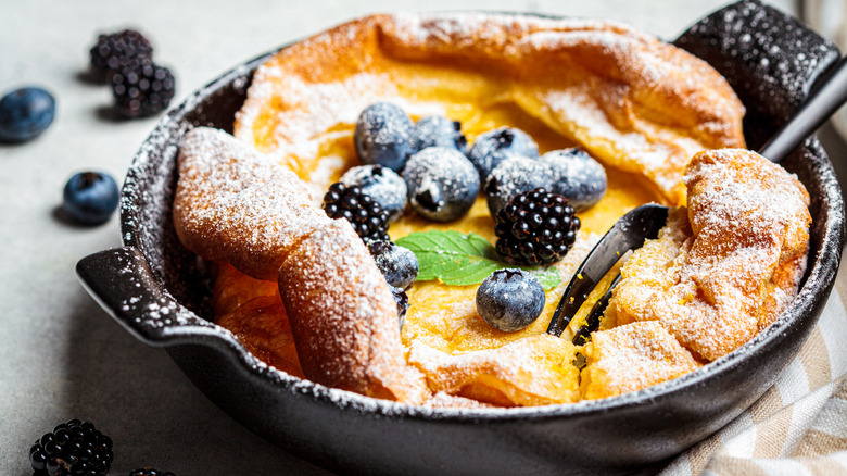 Dutch baby with blueberries in cast iron skillet
