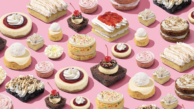 assortment of Crumbl cookies on pink background