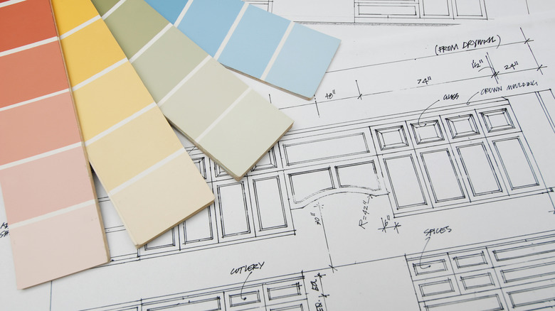 Paint samples over a blueprint of a kitchen