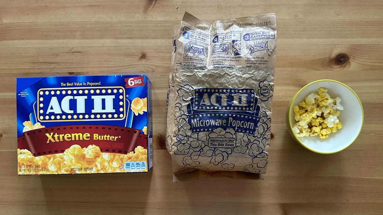A box and bag of Act II Xtreme Butter popcorn beside a small bowl of it