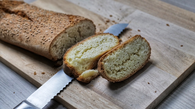 serrated knife cutting crusty bread