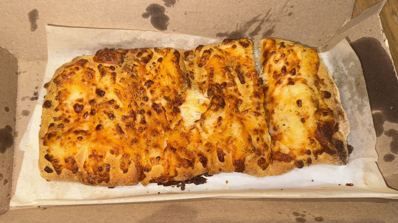 Domino's cheesy bread in cardboard container