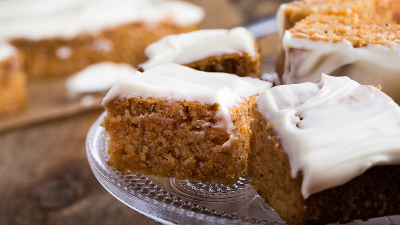 sliced slice cake topped with cream cheese icing