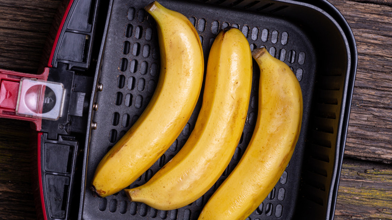 Overhead view of bananas in an air fryer basket