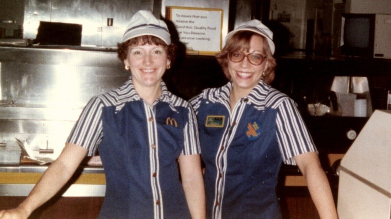Two McDonald's employees in the '80s pose for a photo at work